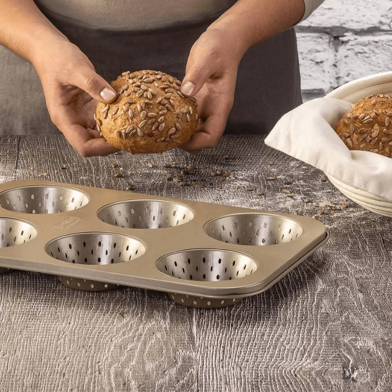 https://www.lcvdesignsndecor.co.za/shop/kitchen-dining/baking-essentials/bakeware/bread-loaf-tins/zenker-perforated-bun-tray/ Zenker Perforated Bun Tray 6 Cups - Mojave Gold Lifestyle 2